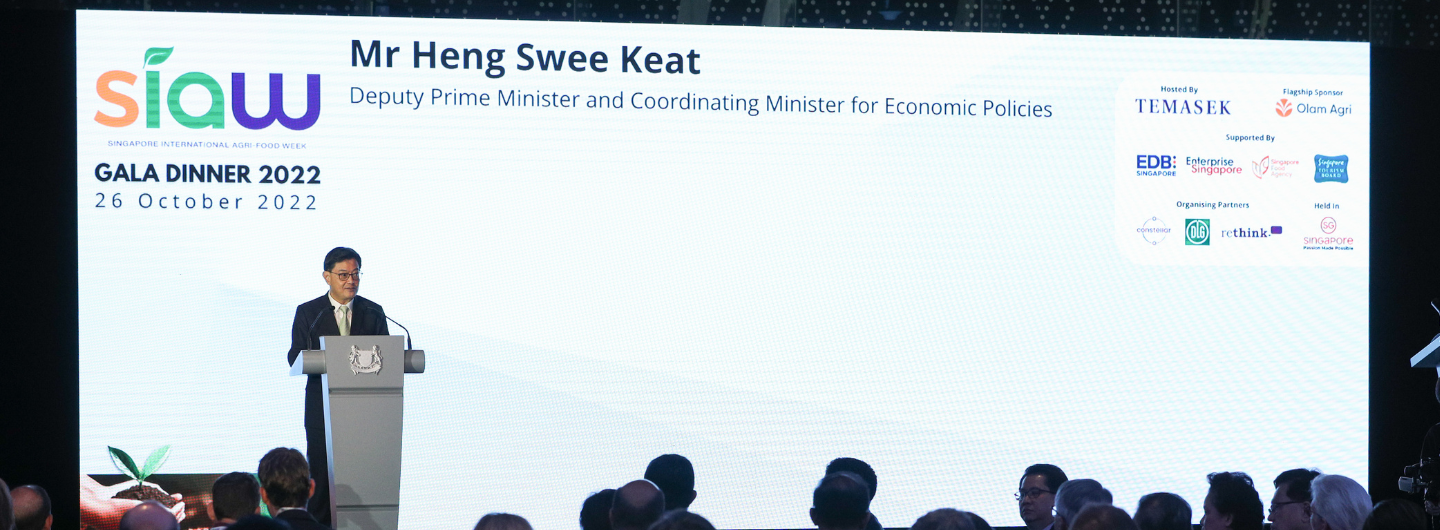 Mr. Heng Swee Keat at SIAW Gala Dinner 2022, speaking at podium with sponsor logos displayed.
